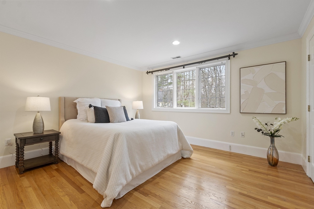 58 Buttrick Lane Carlisle, MA 01741 - Photo 30 of 39 a bedroom with a bed and wooden floor