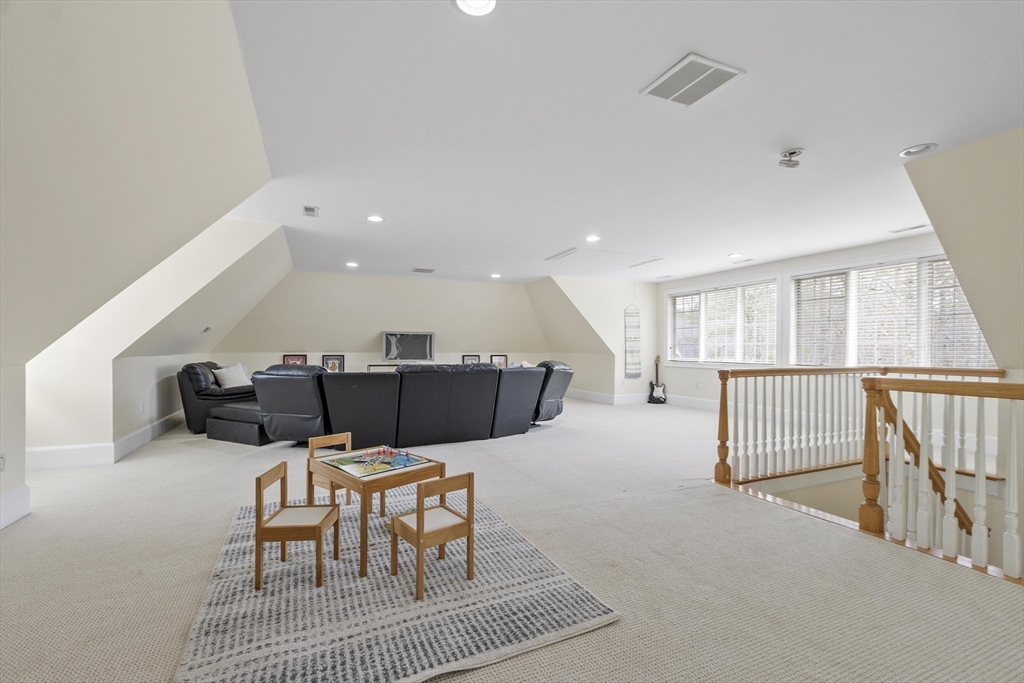 58 Buttrick Lane Carlisle, MA 01741 - Photo 35 of 39 a living room with furniture a rug and kitchen view