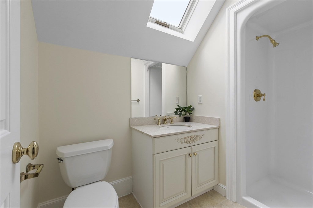 58 Buttrick Lane Carlisle, MA 01741 - Photo 37 of 39 a bathroom with a toilet a sink and mirror