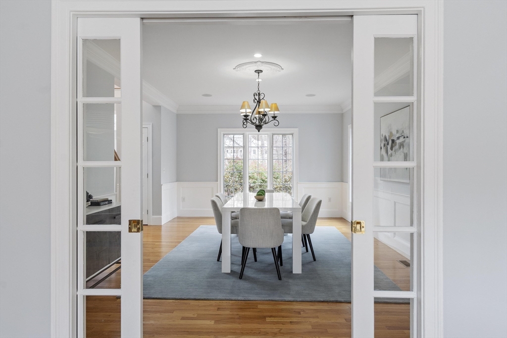 58 Buttrick Lane Carlisle, MA 01741 - Photo 9 of 39 a dining room with furniture a chandelier and wooden floor