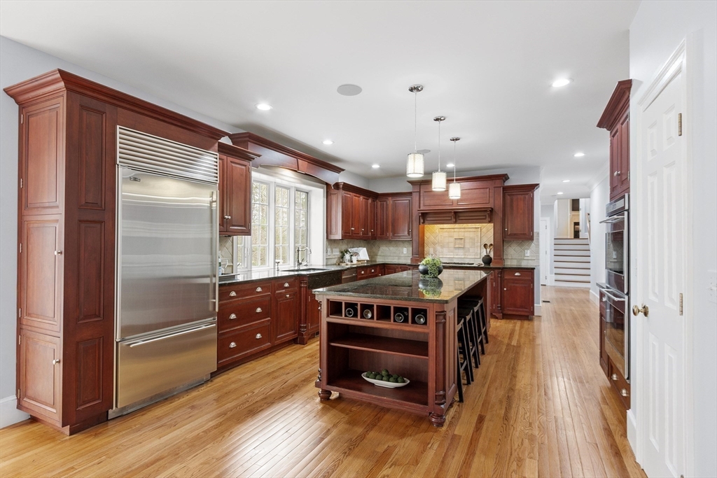 58 Buttrick Lane Carlisle, MA 01741 - Photo 10 of 39 a kitchen with stainless steel appliances granite countertop a stove and a refrigerator