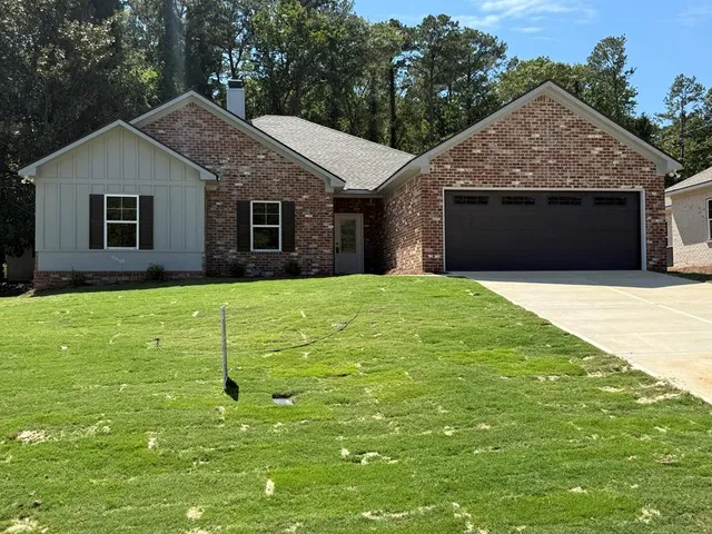 a front view of house with yard and trees