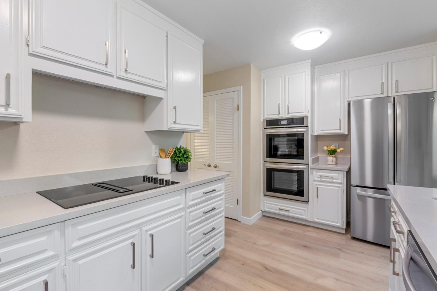 2080 Marich Way, Unit 15 Mountain View, CA 94040 - Photo 12 of 38 a kitchen with granite countertop a refrigerator and a stove top oven
