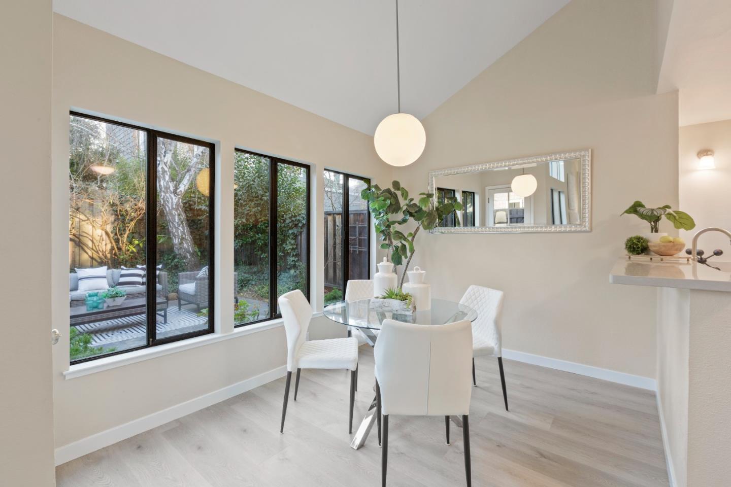 2080 Marich Way, Unit 15 Mountain View, CA 94040 - Photo 15 of 38 a view of a dining room with furniture large windows and wooden floor