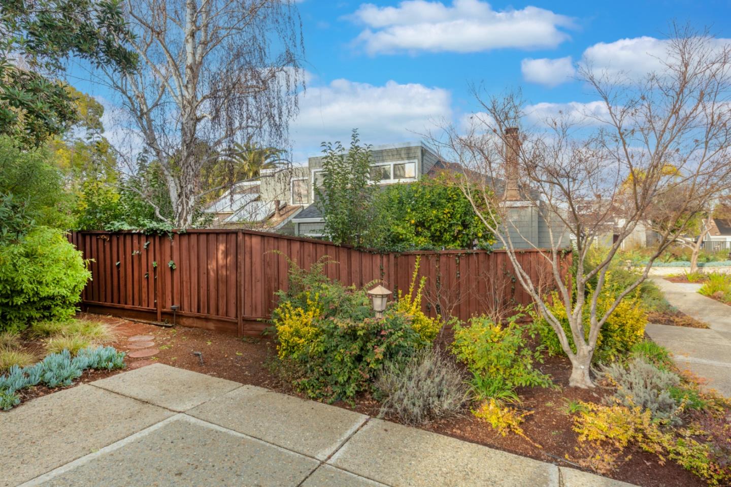 2080 Marich Way, Unit 15 Mountain View, CA 94040 - Photo 34 of 38 a view of backyard with potted plants and wooden fence