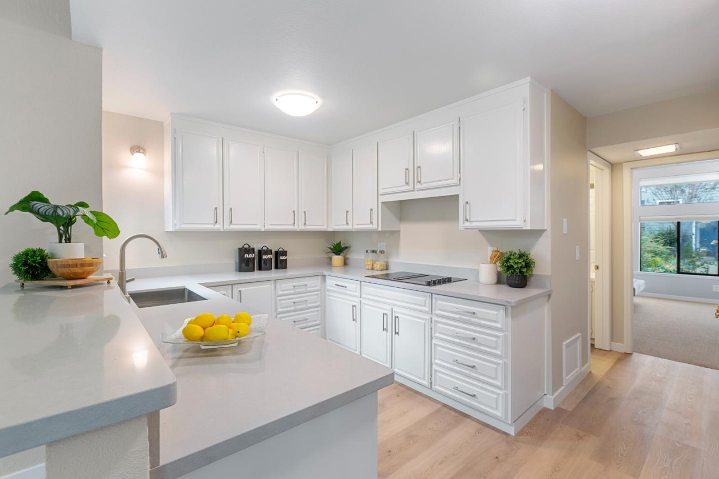 2080 Marich Way, Unit 15 Mountain View, CA 94040 - Photo 10 of 38 a kitchen with a sink a stove cabinets and wooden floor