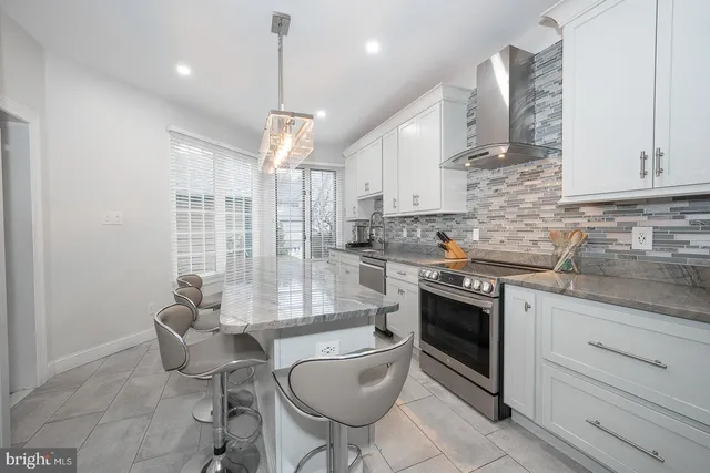 a kitchen with granite countertop a stove sink and cabinets