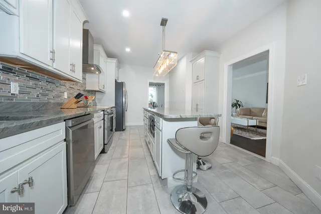 a living room with furniture a wooden floor and a large window
