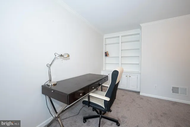 a bedroom with a bed and a lamp