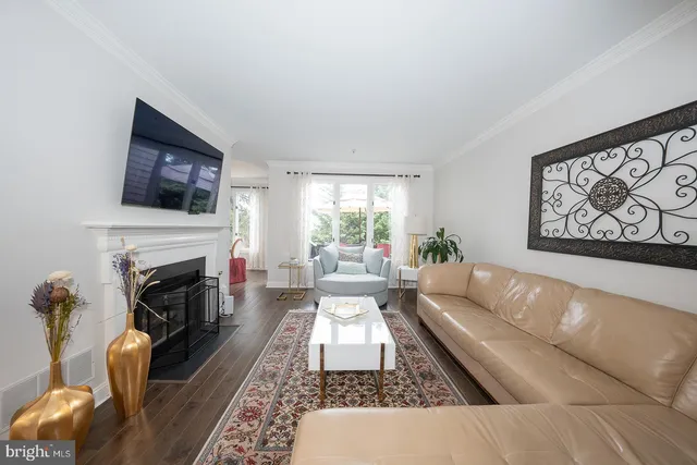 a kitchen with stainless steel appliances granite countertop a sink a stove a refrigerator cabinets and dining table