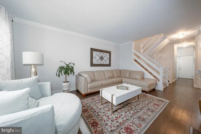 a dining room with furniture and wooden floor