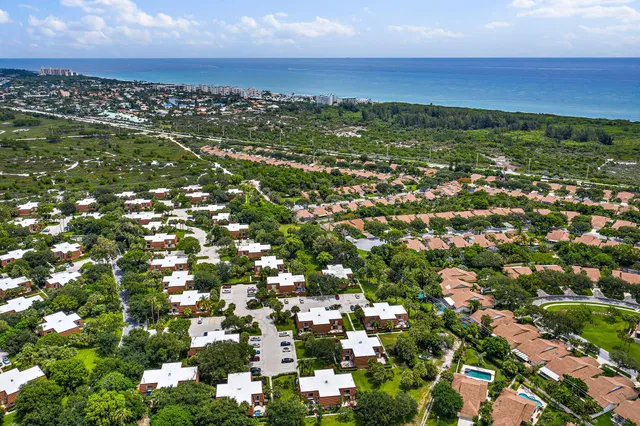 an aerial view of residential houses with city view