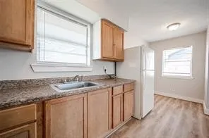 a kitchen with a sink cabinets appliances and a window