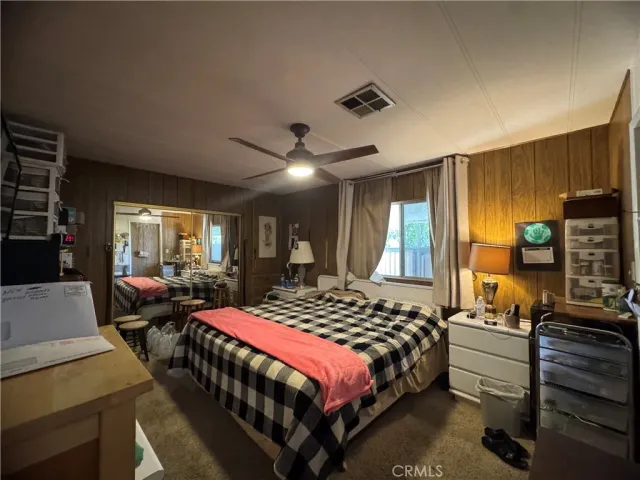 a bedroom with a large bed and a large window