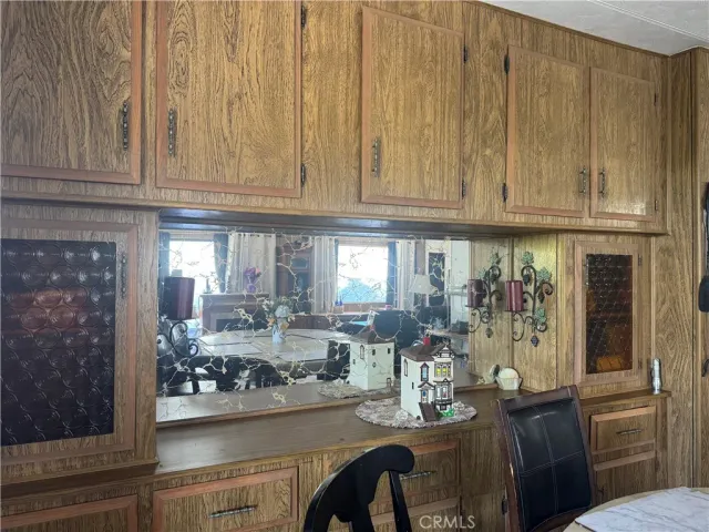 a view of a dining room with granite countertop a couch a stove and a window