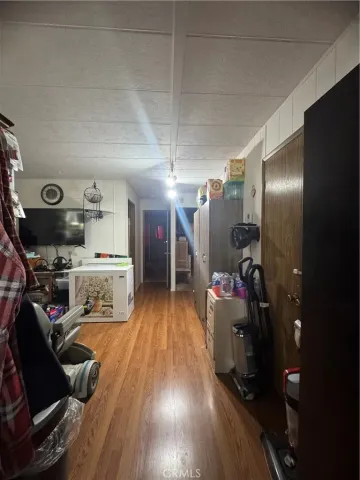 a view of a room with wooden floor