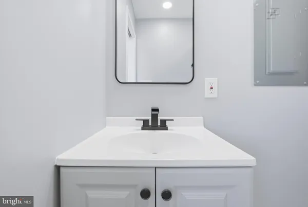 a close view of a sink and a mirror in a bathroom