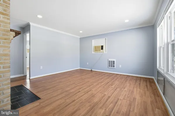 wooden floor in an empty room with a window