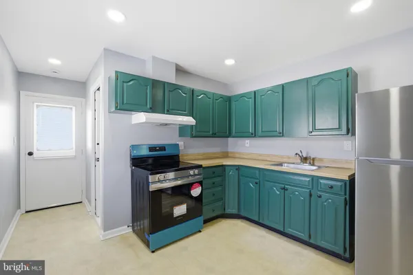 a kitchen with a sink and cabinets