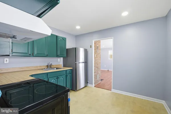 a kitchen with a refrigerator and a sink