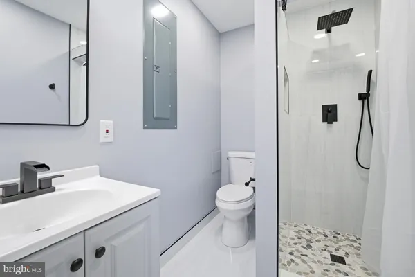 a bathroom with a sink toilet and shower