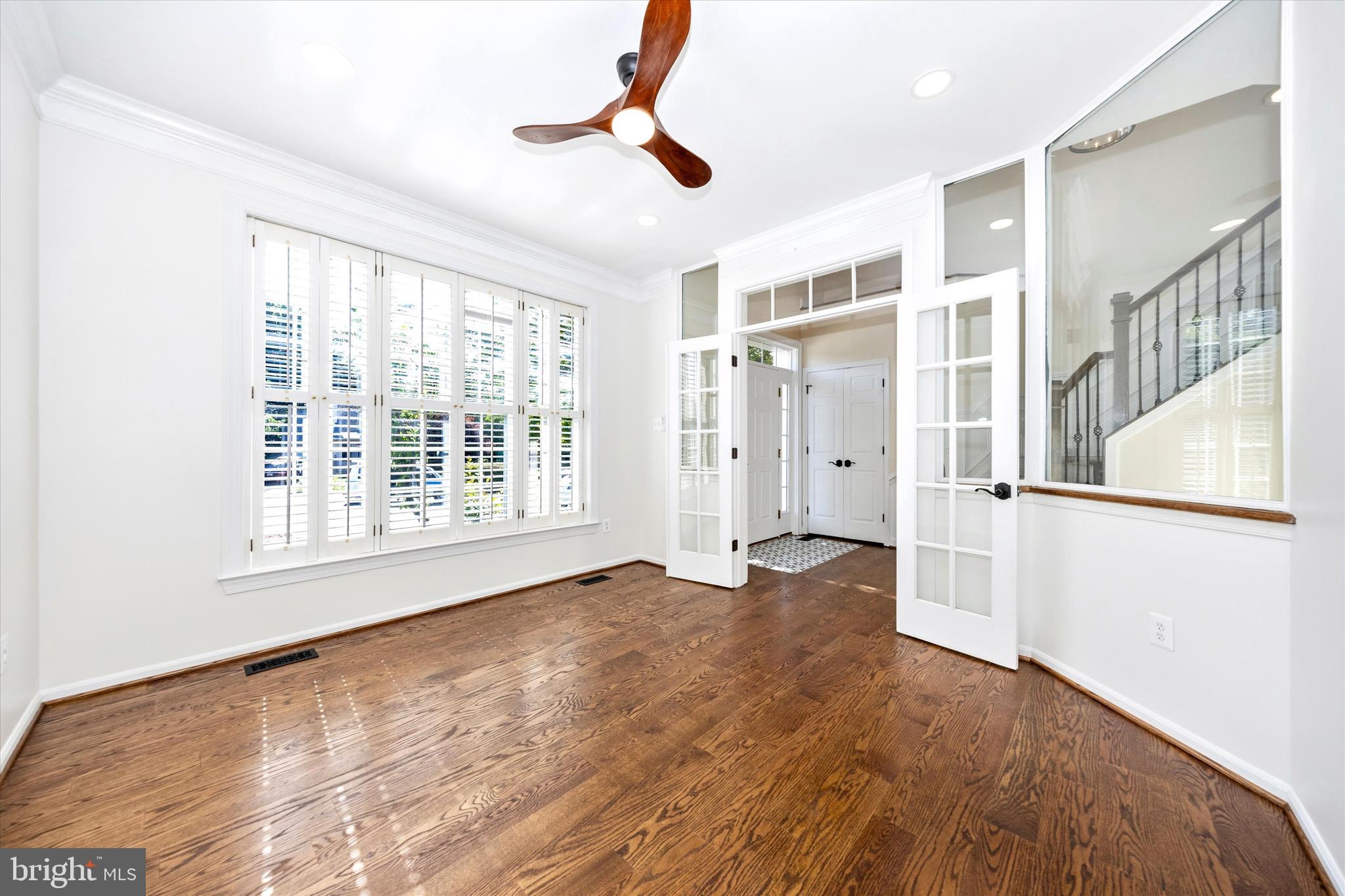 803 Apache Court Frederick, MD 21701 - Photo 4 of 46 a view of an empty room with wooden floor and a window