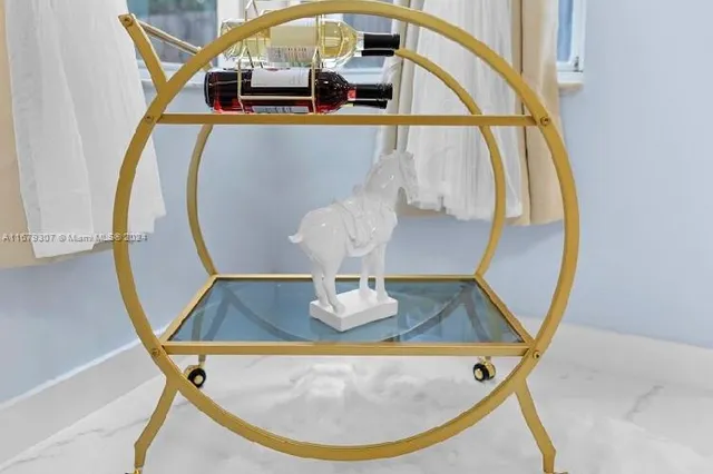 a bedroom with a bed and a flat tv screen on dresser