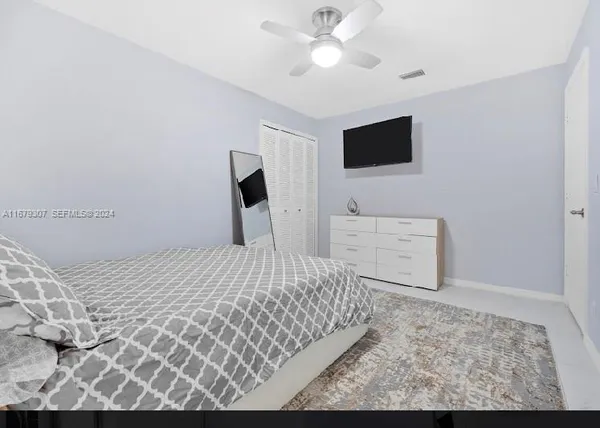 a bedroom with double bed and a window