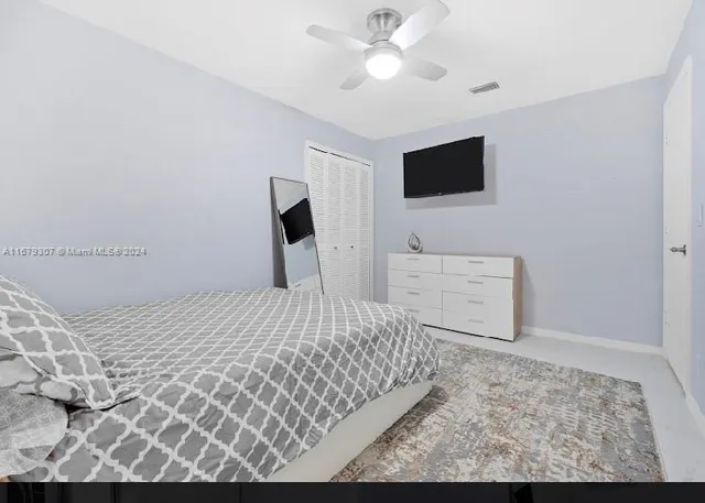 a bedroom with double bed and a window