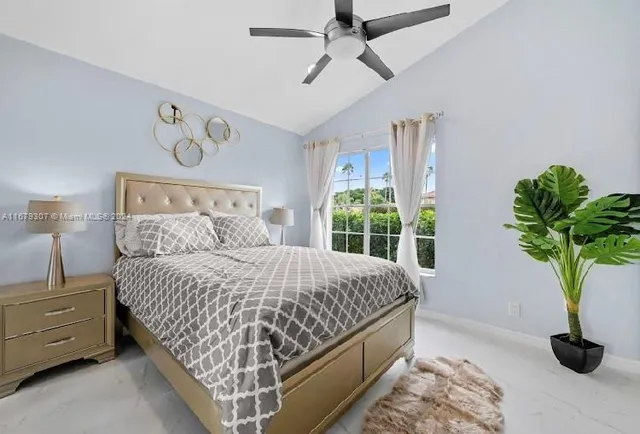 a bedroom with a large bed and a window