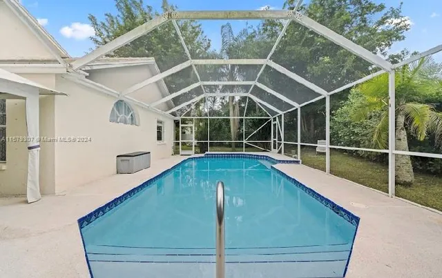 a view of a backyard with a swimming pool