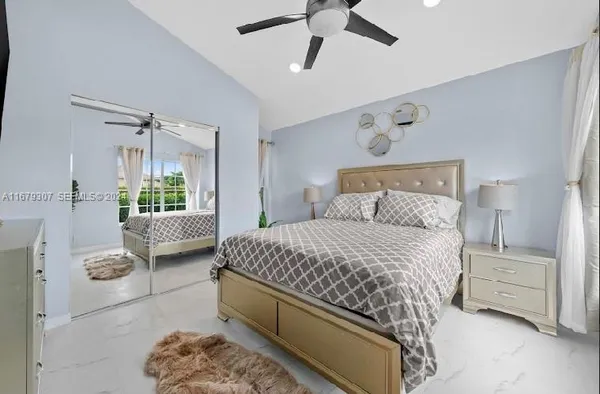 a bedroom with a bed and window