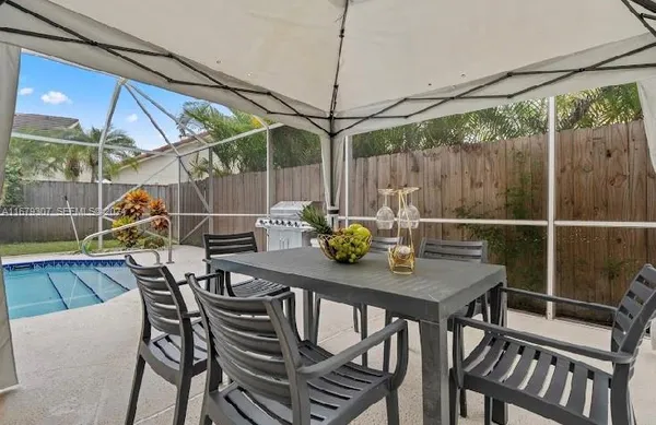 a view of an outside dining space with furniture