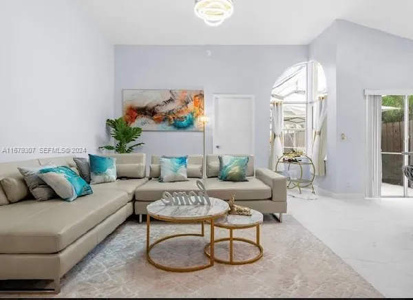 a living room with furniture and a large window