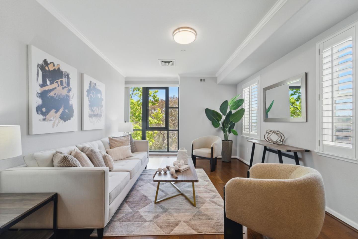 a living room with furniture two window and wooden floor