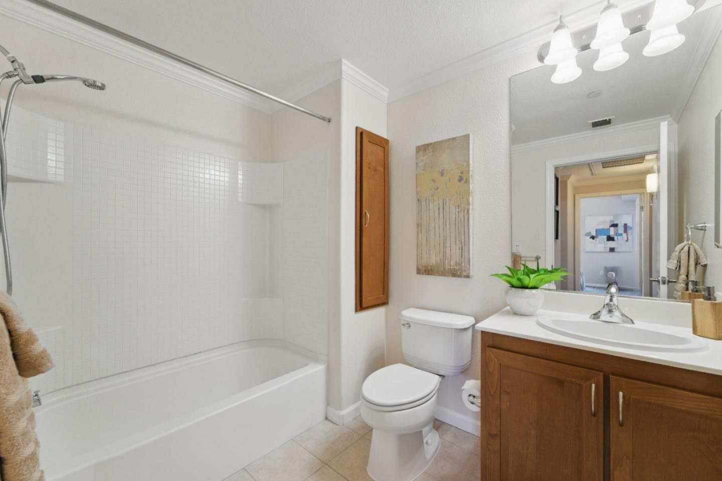 1388 Broadway, Unit 328 Millbrae, CA 94030 - Photo 17 of 25 a bathroom with a bathtub shower sink vanity and toilet