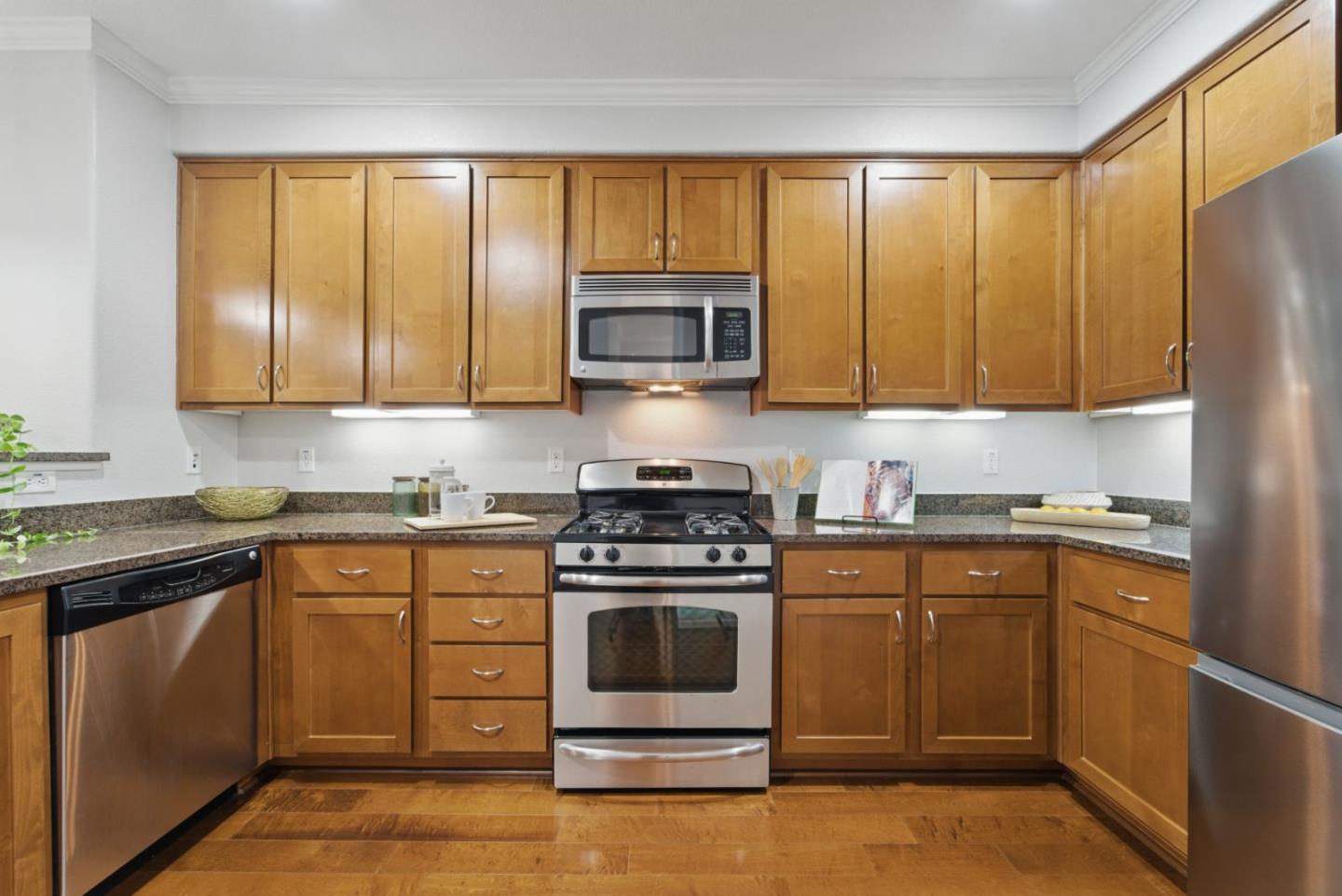 1388 Broadway, Unit 328 Millbrae, CA 94030 - Photo 7 of 25 a kitchen with a stove a sink and a microwave