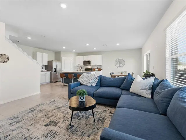 a kitchen with granite countertop cabinets a sink a counter top space and stainless steel appliances