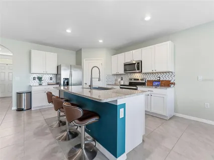 a view of a dining room and livingroom with furniture window and wooden floor
