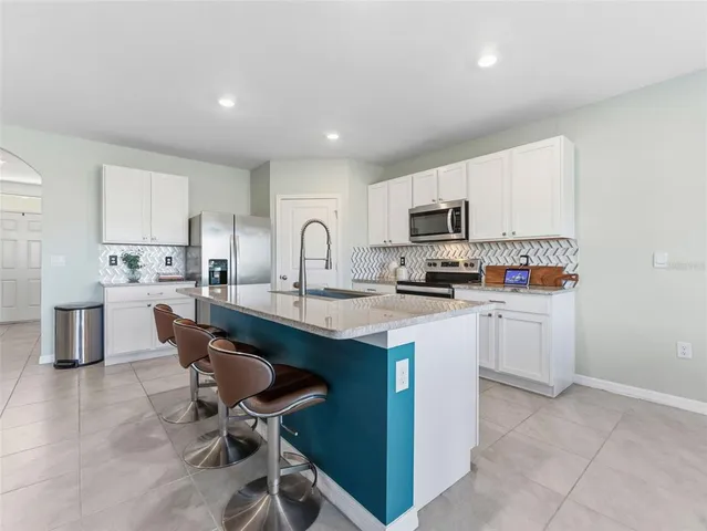 a view of a dining room and livingroom with furniture window and wooden floor