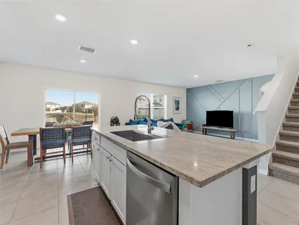 a living room with kitchen island furniture and a wooden floor