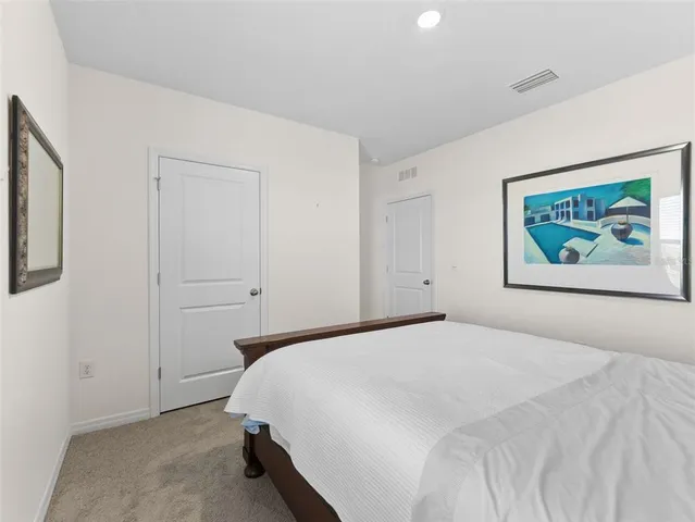 a bedroom with two beds and a window