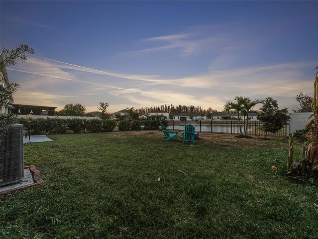a view of a field of grass and trees