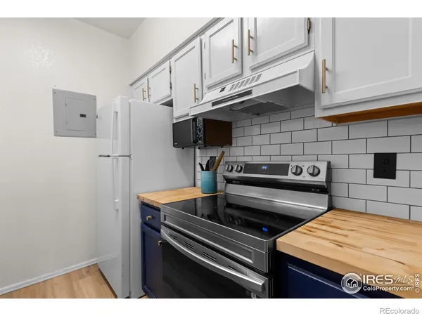 a kitchen with stainless steel appliances a refrigerator and a stove