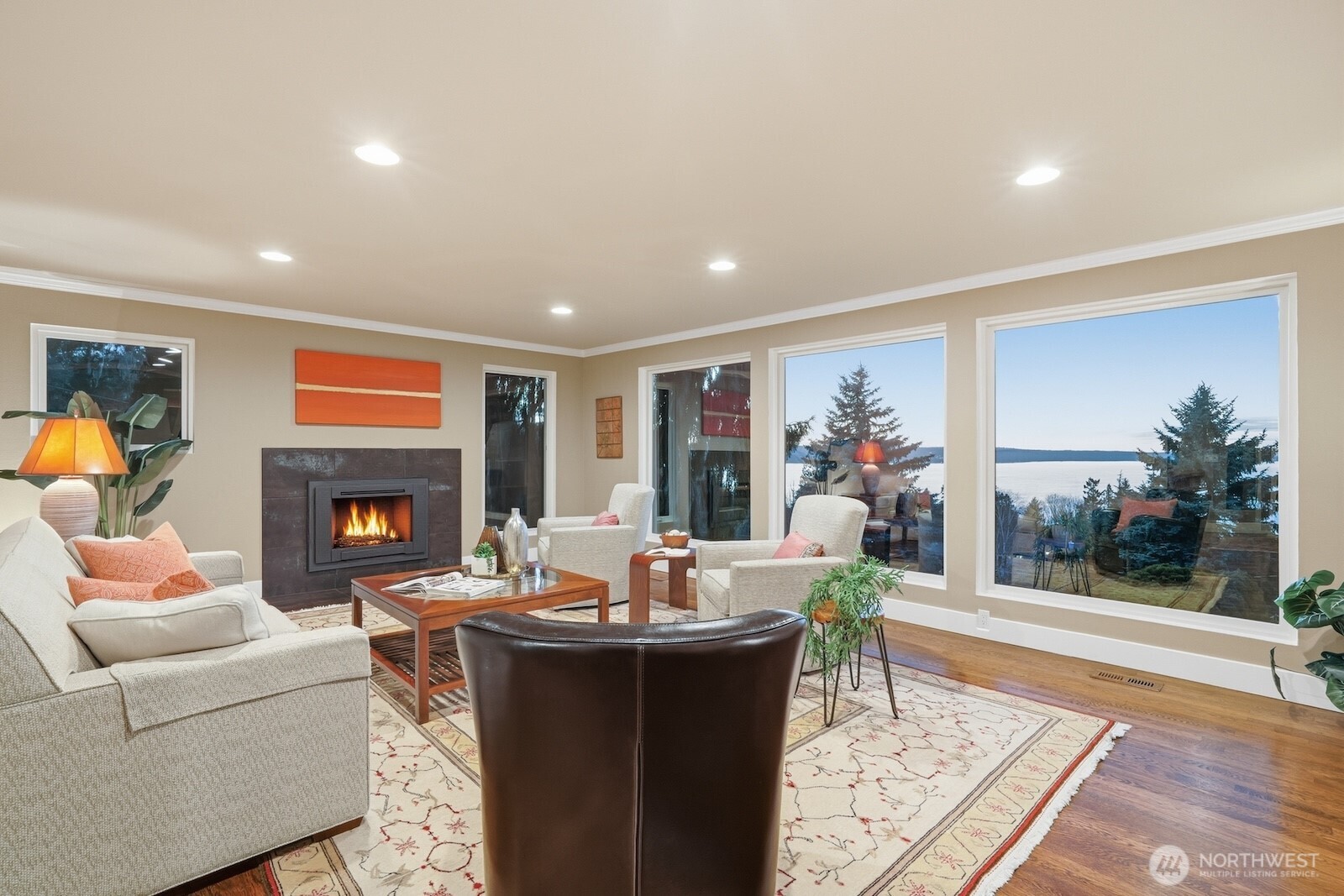 5311 Sound Avenue Everett, WA 98203 - Photo 11 of 40 a living room with furniture a fireplace and a floor to ceiling window