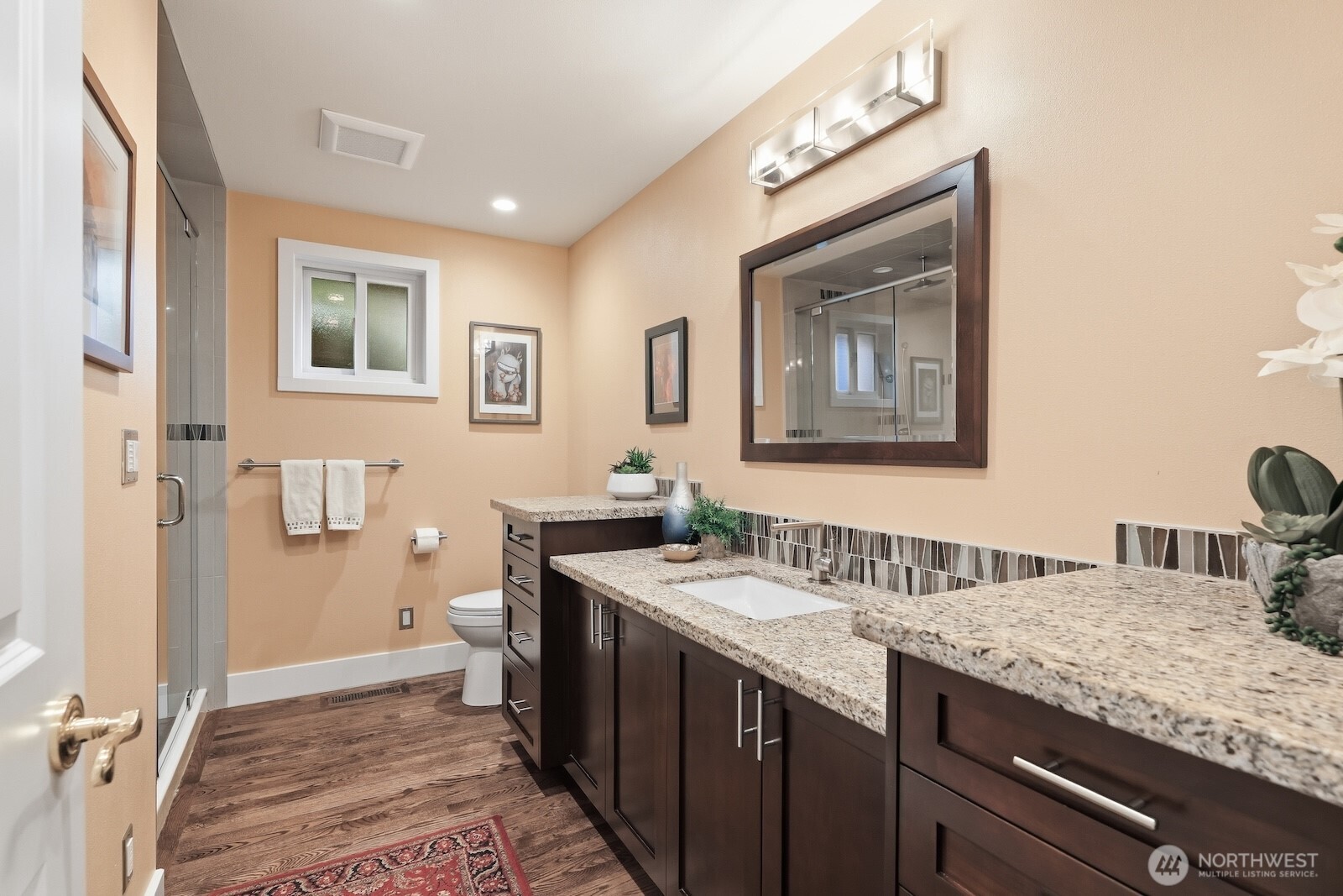 5311 Sound Avenue Everett, WA 98203 - Photo 22 of 40 a bathroom with a granite countertop sink a mirror and a toilet