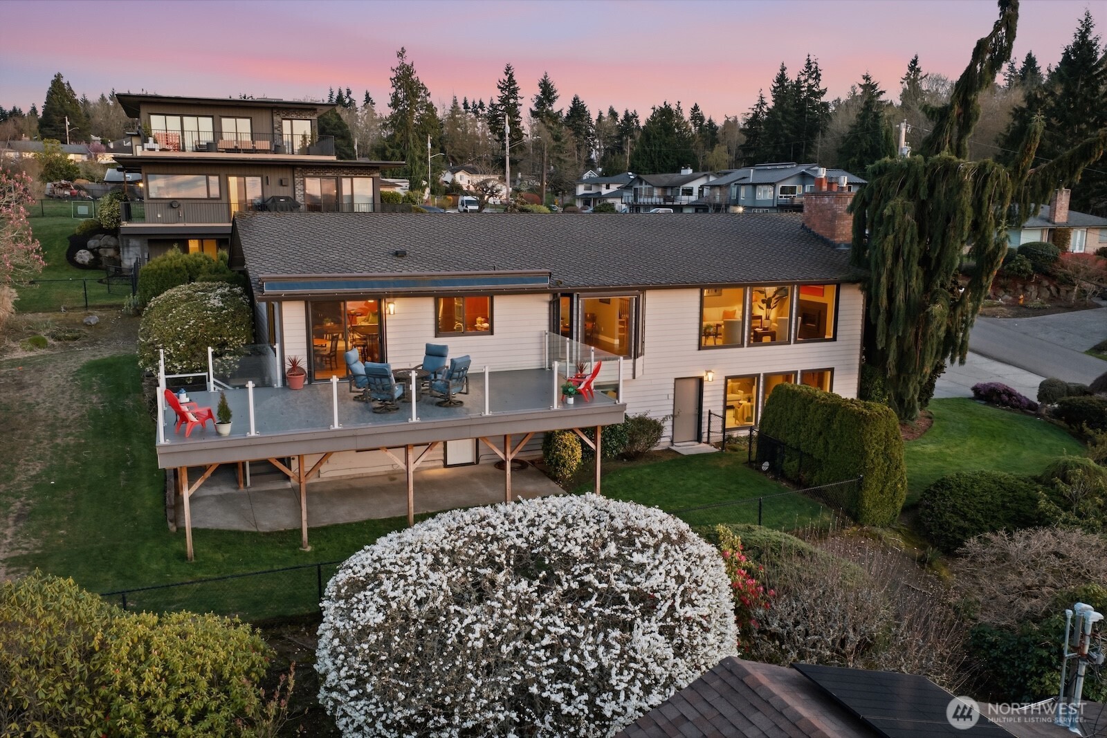 5311 Sound Avenue Everett, WA 98203 - Photo 4 of 40 a view of a patio with table and chairs potted plants and a bench