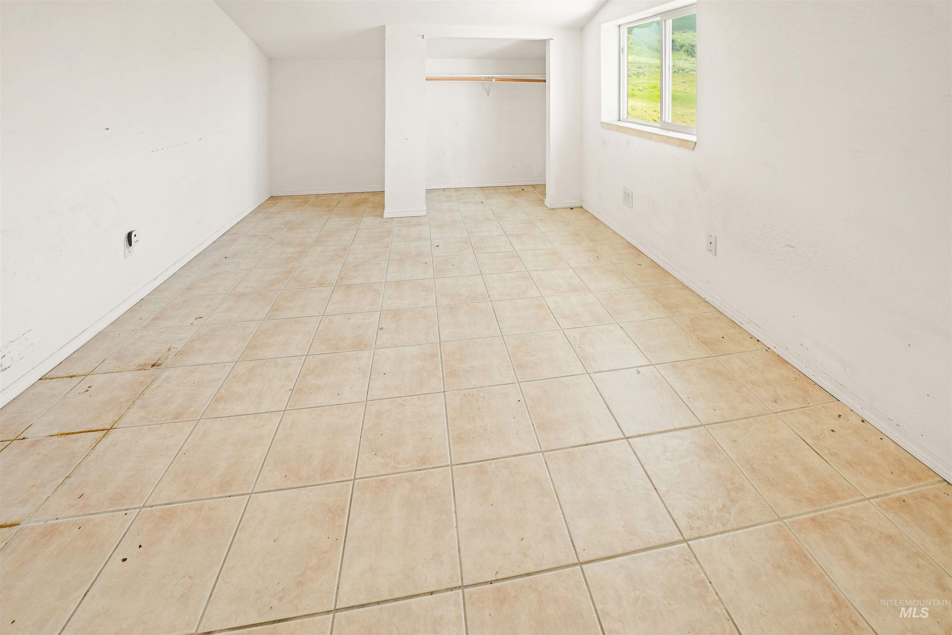 2750 South Perry Lane Clarkston, WA 99403 - Photo 44 of 47 Tile flooring throughout this versatile space, featuring a window for natural illumination and an integrated closet with a hanging rod