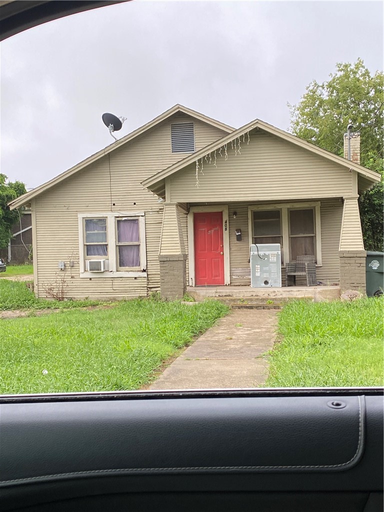 408 East 4th Street Alice, TX 78332 - Photo 1 of 14 a front view of a house with a yard and garage