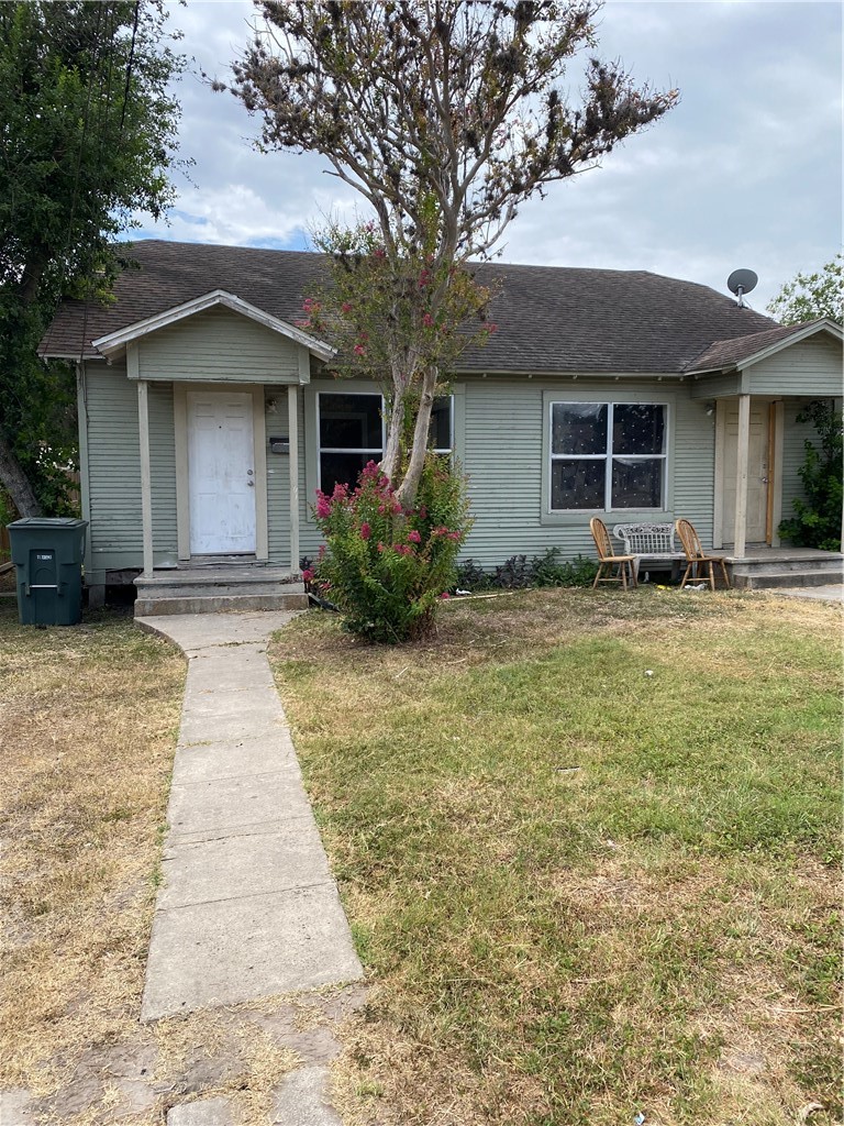408 East 4th Street Alice, TX 78332 - Photo 2 of 14 a front view of a house with garden